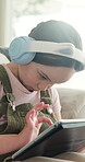 E learning, headphones or child on couch with tablet, online activity or project on academic platform. Homeschool, flare or girl in house with tech, digital lesson or assessment in remote education.