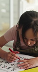 Homework, child and coloring on paper in home for creative activity, problem solving or education. Learning, kid student or circle answer in house for art assessment, visual task or motor development