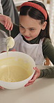 Mother, child and baking in kitchen with mixture, meal preparation and bonding together for development. Above, woman and daughter in home with dessert recipe, help and learning skills for growth.