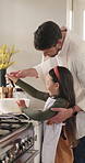 Father, girl or conversation with bowl in kitchen, teaching cooking skills or check batter for meal prep. Instructions, man or child with support for baking in home, bonding or learn for development