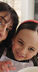 Baking, face and mother laughing with daughter in kitchen of home for bonding, learning or love. Cooking, hug and single parent woman teaching girl child ho to bake in apartment for development