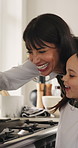 Mother, daughter and cooking in kitchen with pancake, meal preparation and smile for bonding together. Woman, child and happy in house with breakfast food recipe, help and learning skills for growth.