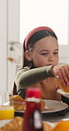 Breakfast, kid and serving pancake in home for nutrition, wellness and help with hand of parent. Morning, hungry girl and pass food in dining room for diet, growth and development with family