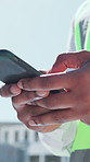 Hands, phone and texting at construction worker in city for contact, notification or chat at building site. Person, engineer or architect with smartphone, mobile app or property development in town