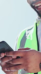 Hands, phone and texting at construction worker in city for contact, notification or smile at building site. Man, engineer or architect with smartphone, mobile app or property development in town