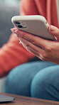 Phone, laptop and hands of woman typing in home for freelance career with creative project. Remote work, computer and female magazined editor with cellphone for email feedback on publishing in house.