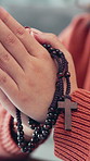 `Prayer, religion and hands of woman with rosary in home for praise, faith or spiritual wellness. Necklace, gospel and female person with praying in house for hope, forgiveness or gratitude in house.