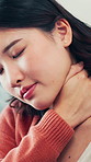 Stress, woman and massage neck pain in home for muscle cramp, stiffness and pinched nerve. Discomfort, asian person and uncomfortable with joint ache, shoulder inflammation and poor posture in house