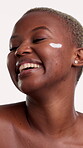 Smile, cream and woman with skincare in studio, collagen moisturizer and facial treatment for beauty. Laugh, dermatology and black person with lotion for hydration, glowing skin or white background