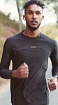 Running, outdoor and man with earphones for fitness, exercise and cardio workout for health. Athlete, runner and person with music, audio and radio for training, endurance and active hobby on road