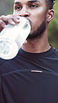 Fitness, health and man with drinking water outdoor for exercise hydration, cardio break and detox. Active, runner and beverage in nature for workout thirst, nutrition and electrolytes for wellness
