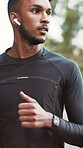 Running, nature and man with earphones for fitness, exercise and cardio workout for health. Athlete, runner and person with music, audio and radio for training, endurance and active hobby outdoor