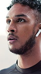 Thinking, sweat and man with earphones for fitness, training and exercise for wellness, health or cardio. Runner, athlete and tired person with audio, podcast and music for intense workout outdoor