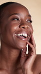 Skincare, laugh and black woman in studio with beauty, natural texture and wellness for spa. Happy, salon and person with touch for smooth skin, dermatology or cosmetics for glow on yellow background