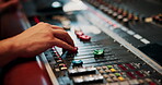 Mixing, hands and audio engineer in music studio with equipment, change volume and album production. Man, sound technician and creativity with technology for editing track, project and record label.