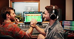 Handshake, producer or happy people with computer in recording studio, mixing success or music production. Celebrate, headphone or sound engineer team with vocal capture for song, shake hands or tech