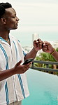 Men, phone and fist bump with pool for vacation, travel and reunion with break. Hotel, summer holiday and people with tech for influencer, social media and greeting with app and luxury resort review