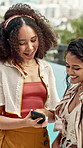 Friends, bonding and phone at resort with summer holiday, social media post and conversation on trip. Women, smile and discussion outdoor at hotel with tech, mobile app or travel website for vacation