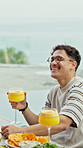 Happy man, laughing and cocktail with fruit for social gathering, dining or event together. Male person, smile or funny joke with glass or food for comedy, humor or dinner conversation at table