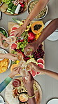 Hands, people and cheers with champagne for brunch reunion, celebration and organic snacks. Above, friends and toast drinks with fruit board, social gathering and bonding together for weekend break