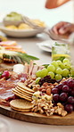 Closeup, friends and charcuterie with food for brunch reunion, organic snacks and special occasion. People, board and healthy fruit for nutrition, social gathering and bonding together for wellness