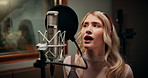 Microphone, woman and singer in studio with headphones for recording music with talent for album. Singing, artist and female musician with audio tech for production on song with media in sound booth.