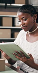 Tablet, box or black woman in office for logistics, ecommerce or supply chain in small business. Tech, planning and happy entrepreneur with order for shipping, stock check or typing for distribution