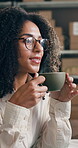Logistics, woman and happy with coffee in warehouse, daydreaming and planning for stock distribution. Small business, supply chain or African person with caffeine drink on break, smile and reflection