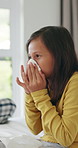 Tissue, relax and child blowing nose in bed for recovery of allergy infection, flu or cold. Sneeze, sick and girl kid with toilet paper in bedroom for healing with illness, sinus or hayfever in house