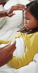 Forehead, girl and thermometer of mother in bedroom of home for checkup, health monitoring or illness. Fever, sick and temperature with daughter in bed for healing, parent care or wellness concern