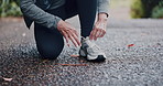 Fitness, nature and woman tying laces for workout, training or running outdoor in park for wellness. Sports, sneakers and hands of mature female person preparing for cardio exercise, health or active