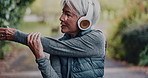 Stretching, outdoor and old woman with exercise, headphones for audio and workout. Runner, training or mature person with wellness, fitness for health benefits and listen to radio, sound and podcast