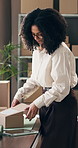 Packaging, box and woman with tablet in office, small business and review shipping address for order. Ecommerce, parcel or entrepreneur with tech for delivery info, startup or send confirmation email