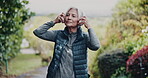 Outdoor, running or senior woman with headphones for fitness, cardio workout or streaming music playlist. Park, endurance training and old person with audio tech for radio, listening and exercise