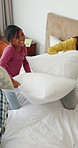 Parents, children and smile on bed for pillow fight, bonding and playful relationship in morning. Family home, siblings and people in bedroom with game, weekend and excited together for childhood fun