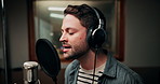 Microphone, singing and man in studio with headphones for recording music with talent for album. Singer, artist and male musician with audio tech for production on song with media in sound booth