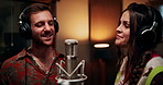 Microphone, singing and couple in studio with headphones for recording music, song or album. Musicians, creative talent and man with woman for production of audio track together in sound booth.