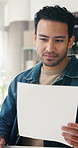Ecommerce, man and reading in office with document, planning or logistics admin for courier delivery. Person, review report or paperwork in workplace for supply chain, distribution or small business.