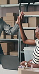 Smile, women and high five with laptop for delivery, distribution or quality control for ecommerce. Small business, warehouse and group of people for supply chain, shipping or supplier checklist