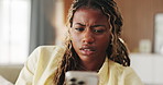 Confused, upset and black woman with phone in home for texting, networking or communication on app. Social media, bad news and female person with tech for fake website, scam or chat in living room