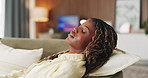 Black woman, tired and sleeping on sofa in home for rest, pillow and relax with eyes closed in lounge. African person, exhausted and break on couch for fatigue, dream or chill in living room at house