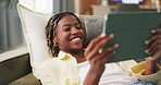 Tablet, smile and black woman on sofa with shock, internet movie or social media in home. Laugh, communication and student on couch with digital tech, app subscription or streaming in living room