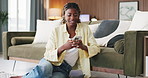 Black woman, phone and smile with texting in home on floor with web chat, notification or online dating. African person, smartphone and typing with mobile app, relax and social network at apartment