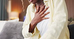 Breathing, chest pain and black woman on sofa in home with asthma, lung disease or pressure. Sick, allergies and African female person with cardiovascular emergency in living room at apartment.