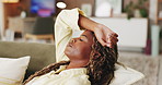 Tired, black woman or breathing on sofa for break, rest or recovery in living room or home. Exhausted, female person or relaxing with deep inhale or exhale on couch for mental health or stress relief