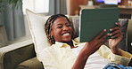 Tablet, smile and black woman on sofa with comedy, internet movie or social media in home. Laughing, communication and student on couch with digital tech, app subscription or streaming in living room