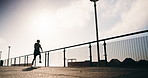 Running, fitness and man in city for exercise, workout and training for cardio, health and wellness. Athlete, sports and person in town with active hobby for practice, endurance and runner challenge