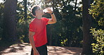 Outdoor, thinking and man with fitness, drinking water and breathing with break, exercise and electrolytes. Liquid, athlete and healthy person with pause, workout and aqua for hydration in forest