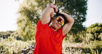Exercise, sunglasses or man with stretching outdoor for post fitness, muscle tension relief or health. Active, runner or shades with arm warm up in nature for workout, flexibility or cardio recovery