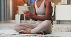 Yoga, hands and typing with phone in home for exercise break, texting and research fitness tips. Woman, mobile app and browsing in house for online workout guide, chat response and wellness article